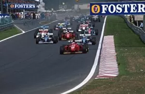 Formula One World Championship: Gerhard Berger Ferrari 412T1B leads at the start from the Williams of Coulthard