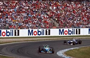 Damon Hill 1996 Collection: Formula One World Championship: Gerhard Berger Benetton B196 leads Winner Damon Hill