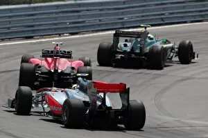 Formula One World Championship: Heikki Kovalainen Lotus T127 leads Fernando Alonso Ferrari F10