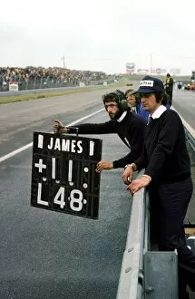 First Victory Gallery: Formula One World Championship: A Hesketh mechanic holds out the pit board from the pit wall for James Hunt