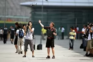 Formula One World Championship: Honda mechanics play with a helicopter in the paddock