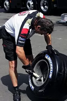 Images Dated 4th May 2006: Formula One World Championship: Honda Racing mechanic hits Michelin tyre with a hammer