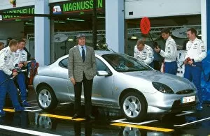 France Collection: Formula One World Championship: Jackie Stewart poses with the new Ford Puma road car