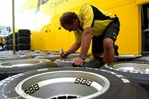 Images Dated 1st May 2003: Formula One World Championship: A Jordan mechanic marks up tyres for the weekend ahead