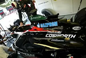 Images Dated 21st March 2003: Formula One World Championship: Jos Verstappen gets into a Minardi Cosworth PS03 in the garage