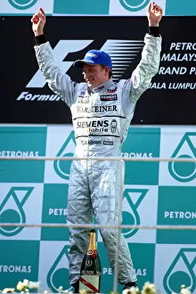 1st Victory Gallery: Formula One World Championship: Kimi Raikkonen McLaren celebrates on the podium after his maiden GP victory