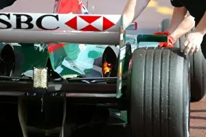 Images Dated 22nd May 2004: Formula One World Championship: Licks of flame from the Jaguar R5 of Mark Webber as he is pushed