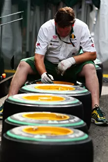 Images Dated 29th July 2010: Formula One World Championship: Lotus mechanic marks Bridgestone tyres