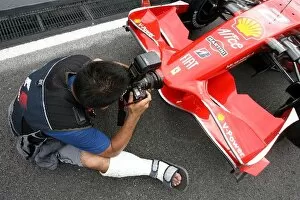 Images Dated 20th March 2008: Formula One World Championship: Mamoru Atsuta Japanese Photographer with a broken foot shoots