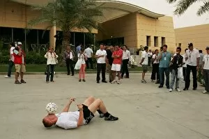 Images Dated 14th April 2007: Formula One World Championship: A man demontrates football skills in the paddock