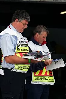 Images Dated 7th July 2005: Formula One World Championship: Marshals read the race programme