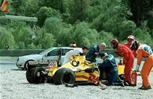 Injured Collection: Formula One World Championship: Marshals tend to Takuma Sato Jordan Honda EJ12