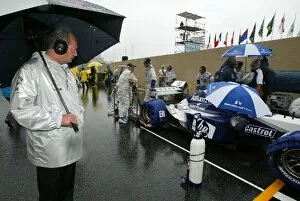 Images Dated 6th April 2003: Formula One World Championship: McLaren boss Ron Dennis takes a close look at the BMW Williams