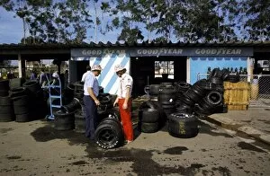 Images Dated 25th February 2003: Formula One World Championship: A McLaren mechanic collects his team├òs tyres from the Goodyear