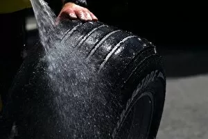 Images Dated 1st July 2005: Formula One World Championship: A mechanic washes a Bridgestone tyre
