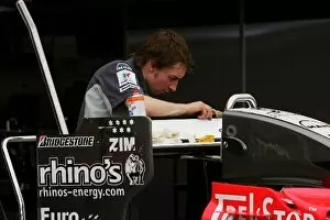 Images Dated 22nd June 2006: Formula One World Championship: MF1 mechanic works on the rear wing of the MF1 M16