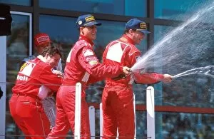 France Collection: Formula One World Championship: Michael Schumacher Ferrari and Eddie Irvine Ferrari celebrate