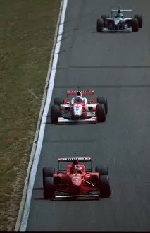 Formula One World Championship: Michael Schumacher Ferrari F310, 4th place leads David Coulthard, 5th
