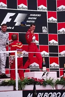 Formula One World Championship: Michael Schumacher Ferrari celebrates victory as David Coulthard McLaren