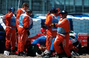 Formula One World Championship: Michael Schumacher lying by his car after breaking his leg in an accident on lap 1