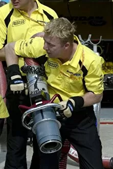 Images Dated 12th June 2003: Formula One World Championship: Mick Gomme Jordan mechanic practices refuelling