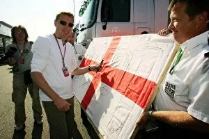 Images Dated 9th June 2006: Formula One World Championship: Mika Hakkinen signs a large England flag