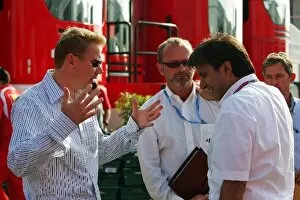Images Dated 8th June 2006: Formula One World Championship: Mika Hakkinen talks with Pasquale Lattuneddu of the FOM