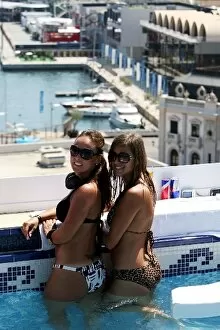 Formula One World Championship: Monika and Natalia watch the action from the Red Bull roof top race day pool party