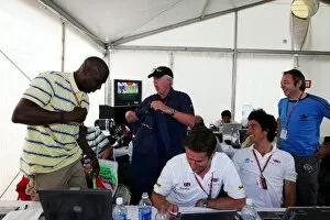 Images Dated 25th June 2006: Formula One World Championship: Patrick Sutton Getty Images digital technician receives an