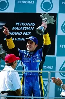 Images Dated 24th March 2003: Formula One World Championship: Third placed Fernando Alonso Renault receives his