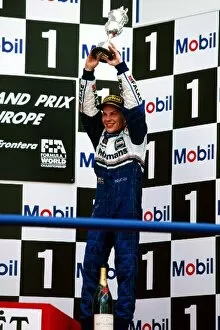 Podium Collection: Formula One World Championship: Third placed Jacques Villeneuve Williams celebrates becoming