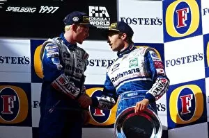 Team Mates Collection: Formula One World Championship: The podium: Race winner Jacques Villeneuve shakes hands with third