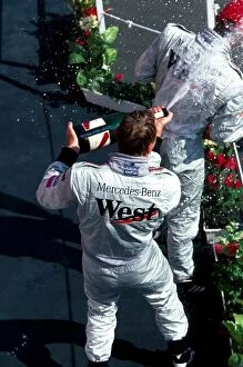 Images Dated 26th July 2005: Formula One World Championship: The podium: race winner Mika Hakkinen McLaren