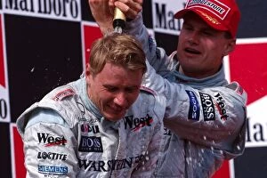 Images Dated 26th July 2005: Formula One World Championship: The podium, race winner Mika Hakkinen McLaren