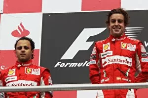 Formula One World Championship: The podium: second placed team mate Felipe Massa Ferrari with race winner Fernando