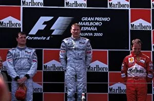 Formula One World Championship: The podium finishers David Coulthard McLaren 2nd, Mika Hakkinen McLaren 1st