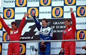 Formula One World Championship: The podium finishers Michael Schumacher Ferrari 2nd, Jacques Villeneuve Williams 1st