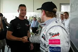 Team Mates Gallery: Formula One World Championship: Race retiree David Coulthard McLaren congratulates team mate Kimi