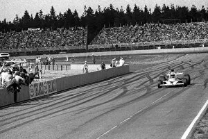 Checkered Gallery: Formula One World Championship: Race winner Denny Hulme McLaren M23 celebrates as he takes