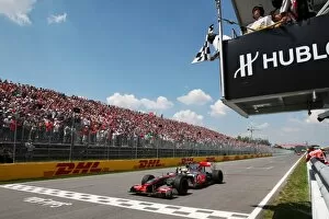Formula One World Championship: Race winner Lewis Hamilton McLaren MP4/25 takes the chequered flag at the end of