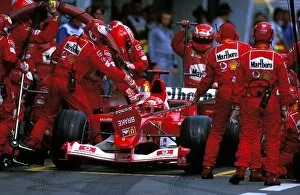 Formula One World Championship: Race winner Michael Schumacher Ferrari F2003-GA suffered a fire at his first Pit Stop