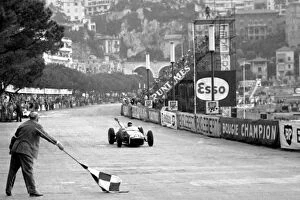 Flag Gallery: Formula One World Championship: Race winner Stirling Moss Lotus 18 crosses the finish line