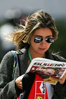 Images Dated 12th March 2006: Formula One World Championship: Rafaela Bassi girlfriend of Felipe Massa Ferrari reads the Red