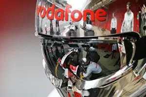 Formula One World Championship: A reflection of Lewis Hamilton McLaren MP4 / 25 in a mechanics helmet