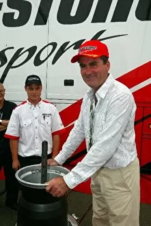 Images Dated 19th July 2003: Formula One World Championship: Richard Keys Sky TV Presenter learns how to fit an F1 tyre onto