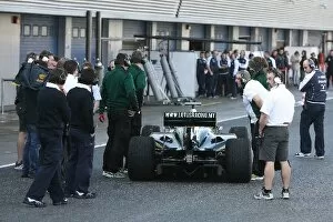 Formula One World Championship: Rival team engineers have a close look at the Lotus T127 after it stops in the pitlane
