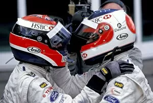 Nurburgring Collection: Formula One World Championship: Rubens Barrichello celebrates with Johnny Herbert in Parc Ferme
