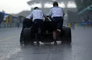 Images Dated 21st March 2003: Formula One World Championship: Sauber mechanics push a car through the rain