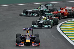 Sao Paulo Gallery: Formula One World Championship: Sebastian Vettel Red Bull Racing RB9 leads Nico Rosberg Mercedes