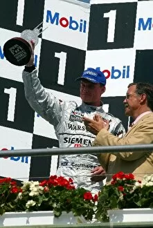 Images Dated 3rd August 2003: Formula One World Championship: Second placed David Coulthard McLaren celebrates on the podium